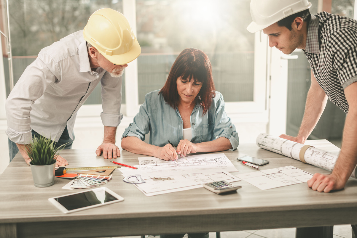 Architects working on plans, light effect